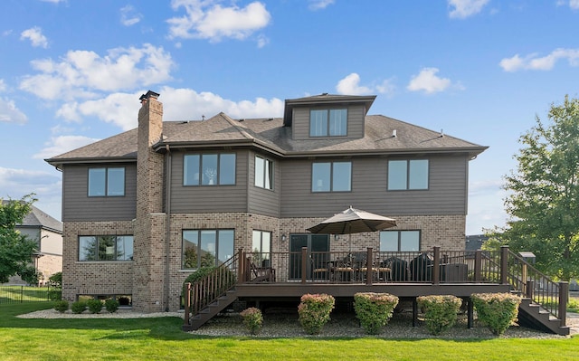 back of house with a lawn, a deck, stairway, and brick siding