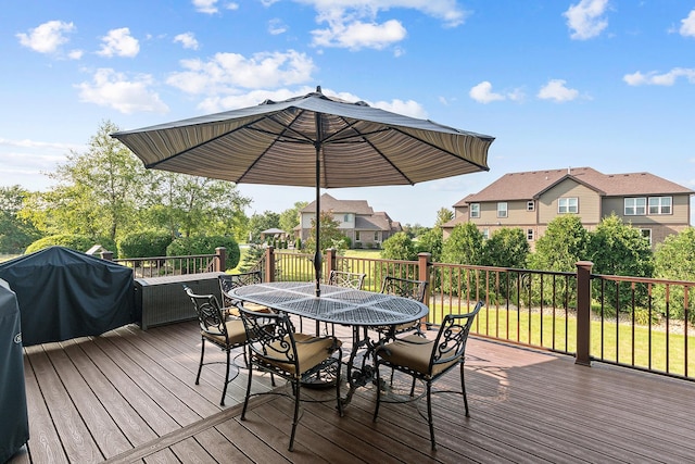 wooden terrace with a residential view and outdoor dining area