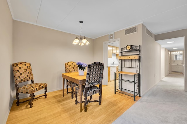 2900 Maple Ave Unit 5A, Downers Grove, IL 60515 - dining room with crown molding, baseboards, a notable chandelier, and visible vents
