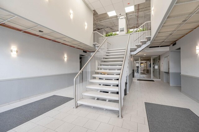 7234 W N Ave Unit 1005, Elmwood Park, IL 60707 - stairs featuring a towering ceiling and tile patterned floors