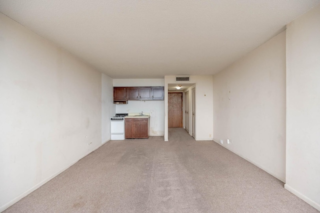 7234 W N Ave Unit 1005, Elmwood Park, IL 60707 - unfurnished living room with a sink, visible vents, and light colored carpet