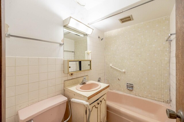 7234 W N Ave Unit 1005, Elmwood Park, IL 60707 - full bathroom with tile walls, toilet, vanity, and washtub / shower combination