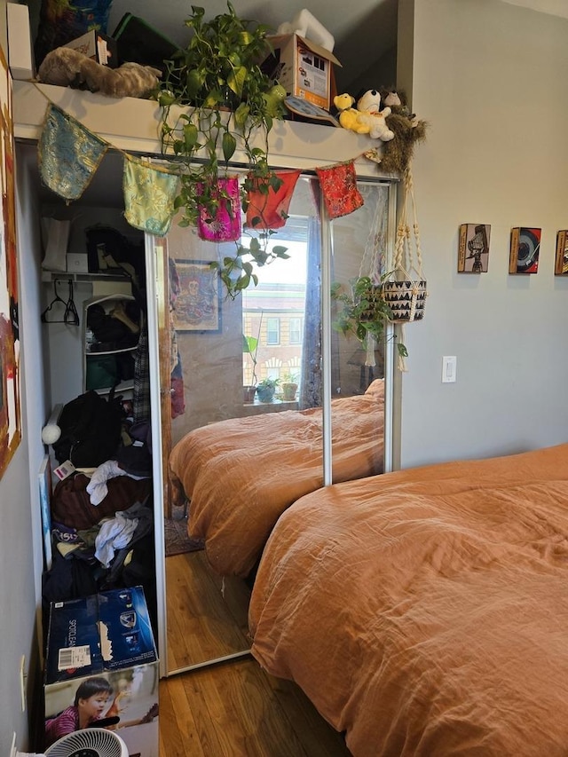 bedroom featuring access to outside and wood finished floors