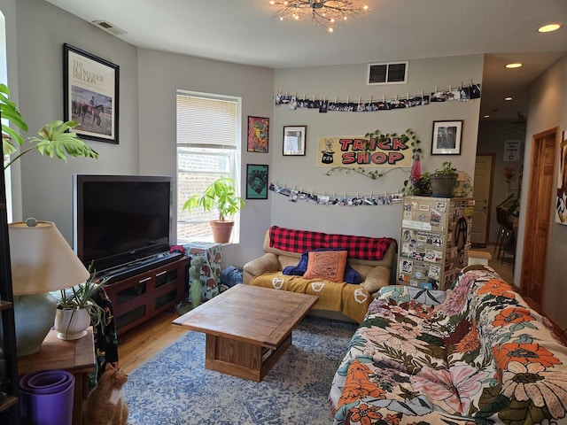living room featuring recessed lighting, wood finished floors, and visible vents