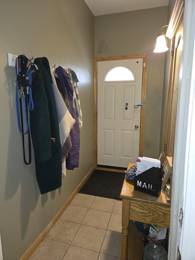 tiled foyer featuring baseboards