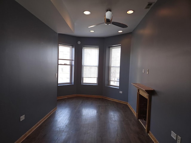 unfurnished living room featuring visible vents, baseboards, ceiling fan, and a wealth of natural light