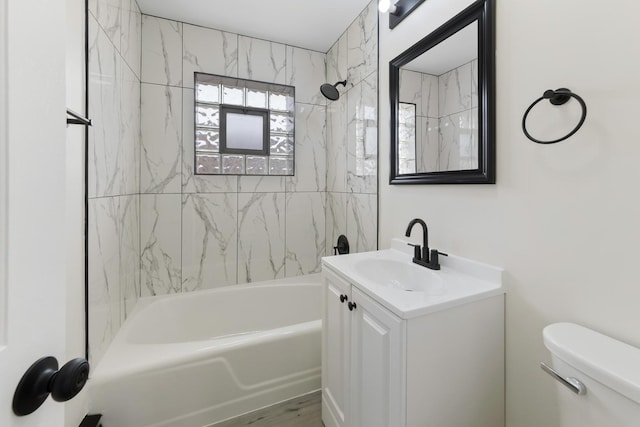bathroom with vanity, shower / bathing tub combination, and toilet