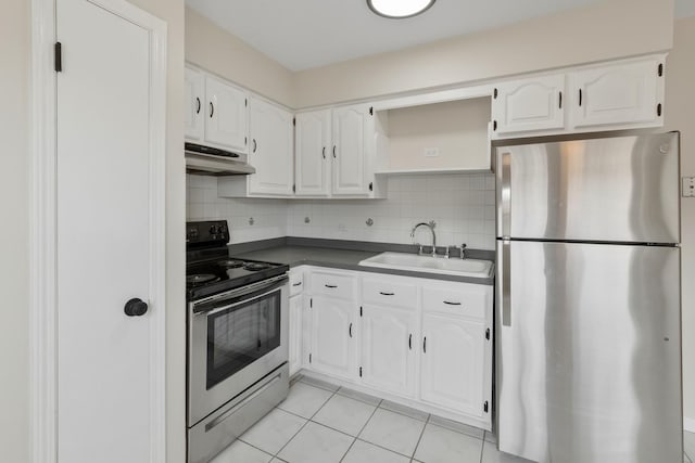 kitchen featuring appliances with stainless steel finishes, dark countertops, open shelves, a sink, and white cabinetry