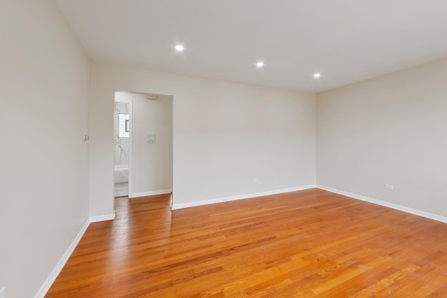 unfurnished room featuring recessed lighting, baseboards, and light wood-style flooring