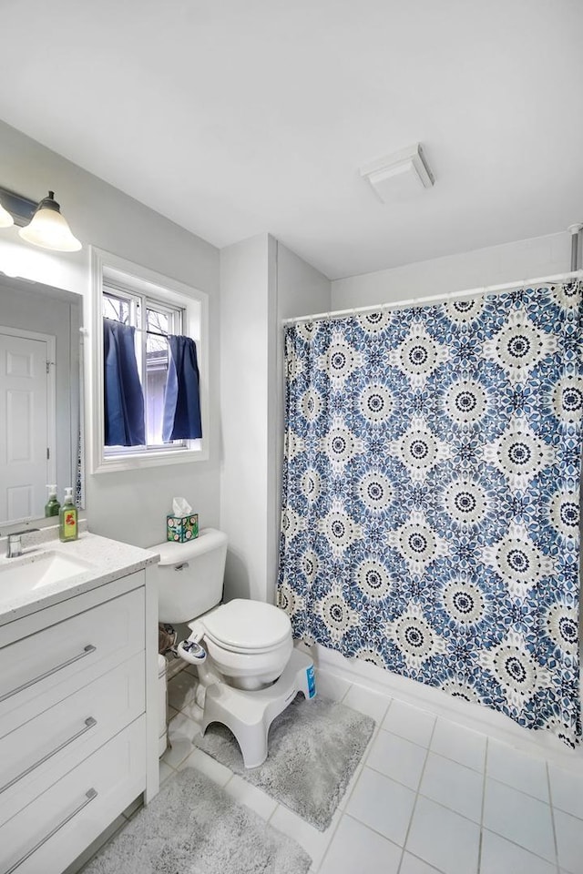 full bathroom featuring toilet, a shower with shower curtain, tile patterned flooring, and vanity