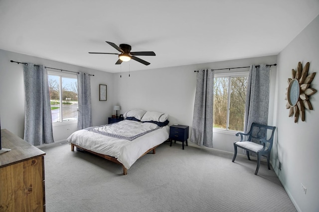 bedroom featuring baseboards, multiple windows, and carpet flooring