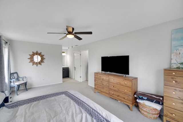 bedroom featuring carpet floors, baseboards, ceiling fan, and ensuite bath