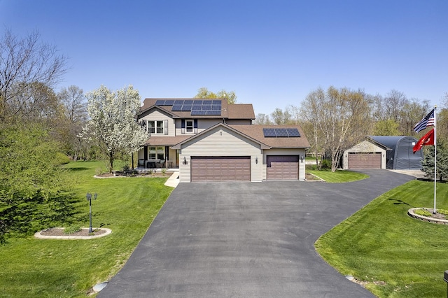 309 Kurt Ln, Kirkland, IL 60146 - traditional-style house with a garage, a front lawn, roof mounted solar panels, and driveway