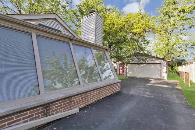 6029 Osage Ave, Downers Grove, IL 60516 - view of property exterior featuring a chimney, an outdoor structure, and a detached garage