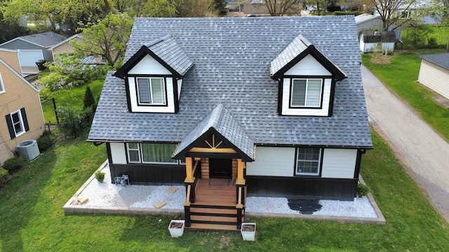 10847 Carpenter St, Mokena, IL 60448 - view of front facade featuring board and batten siding, cooling unit, a shingled roof, and a front lawn