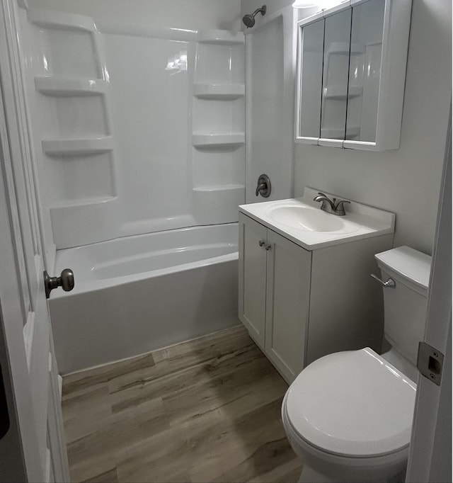 full bathroom with toilet, tub / shower combination, wood finished floors, and vanity