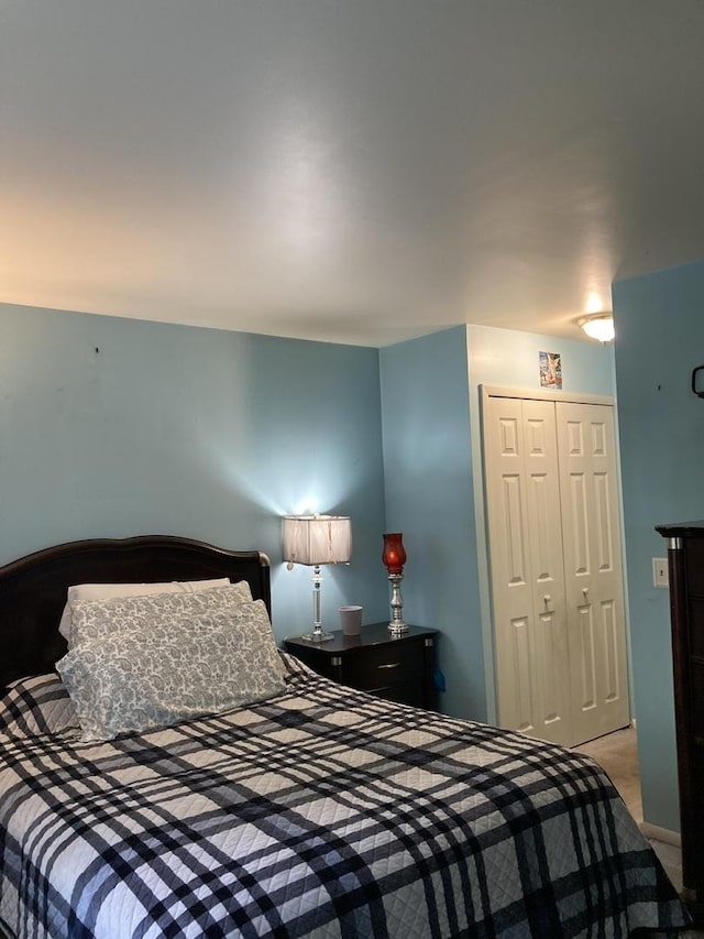 bedroom with light carpet and a closet