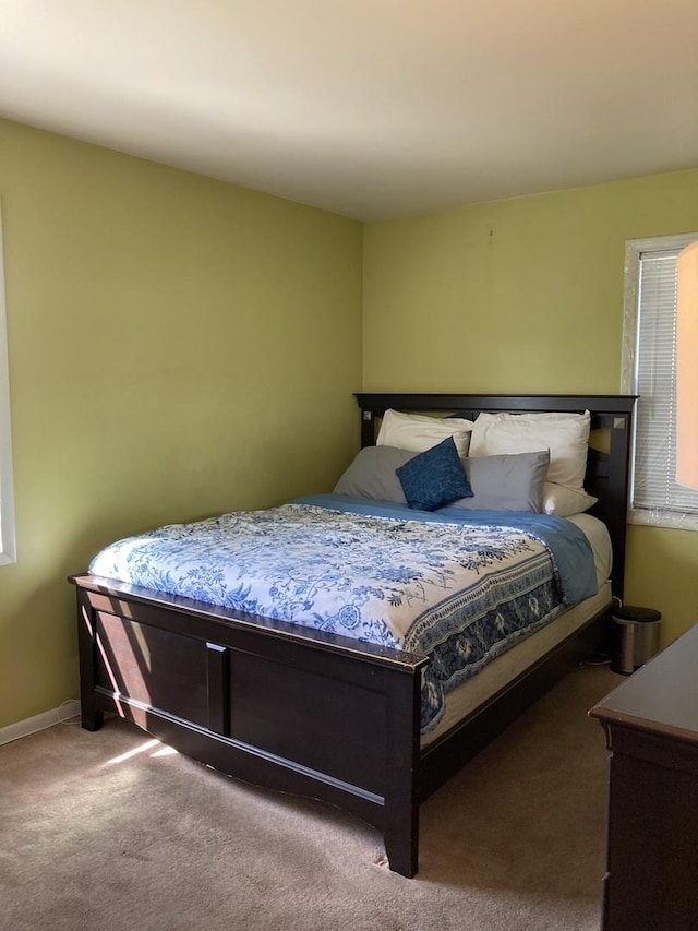 carpeted bedroom with baseboards