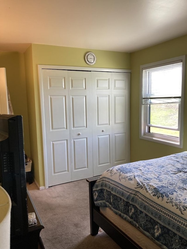 bedroom featuring a closet and carpet flooring