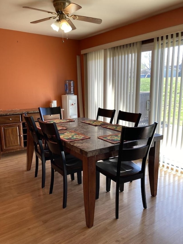 dining room featuring light wood-style floors and a ceiling fan