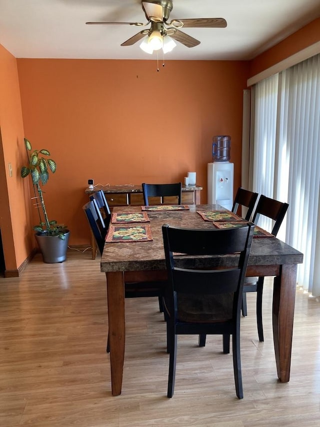 dining room with ceiling fan and light wood-style floors