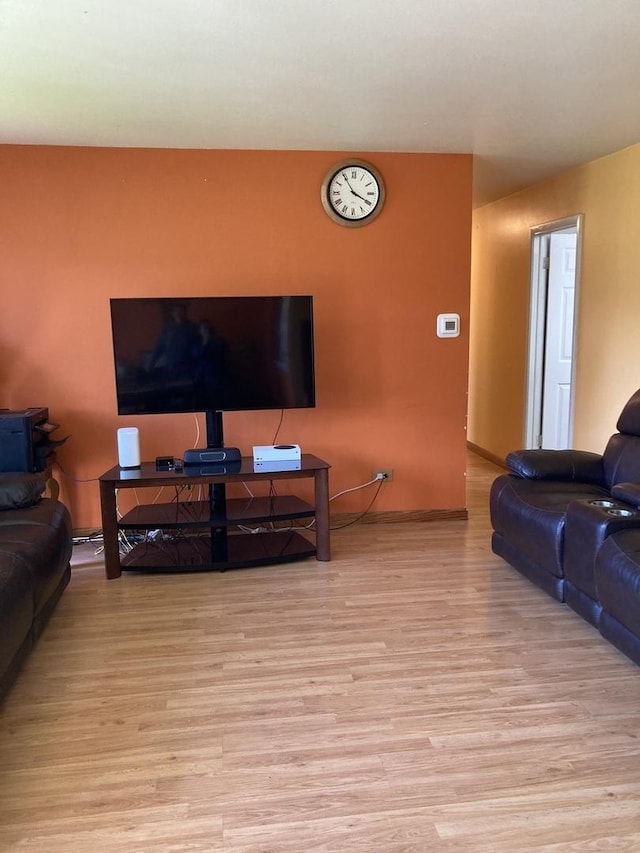 living area with baseboards and light wood finished floors