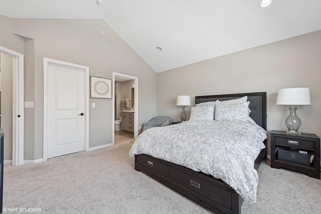 bedroom featuring light carpet, baseboards, recessed lighting, connected bathroom, and vaulted ceiling