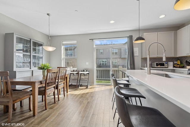 dining room with recessed lighting and light wood-style flooring