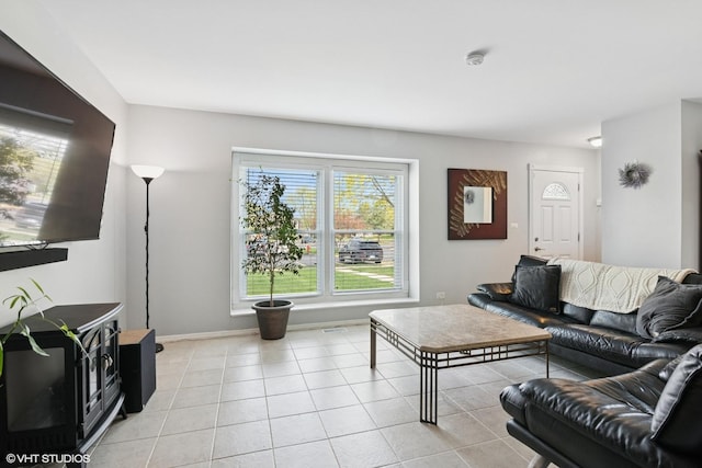 living area with light tile patterned floors and baseboards