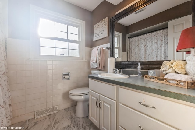 824 Elm St, Flossmoor, IL 60422 - full bathroom with marble finish floors, toilet, vanity, tile walls, and a wainscoted wall