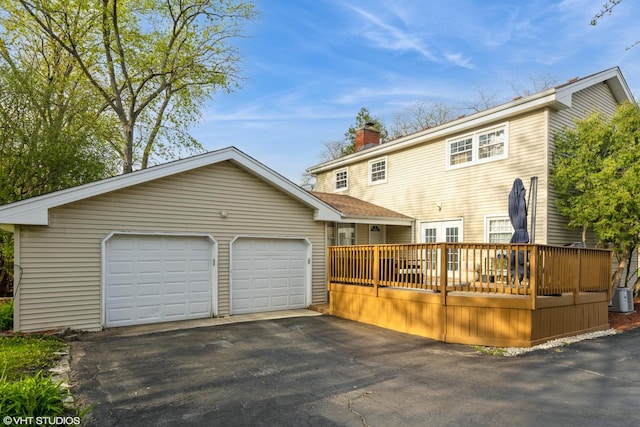 824 Elm St, Flossmoor, IL 60422 - back of property with asphalt driveway, a deck, a garage, and a chimney