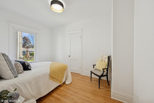 bedroom featuring light wood-type flooring and baseboards