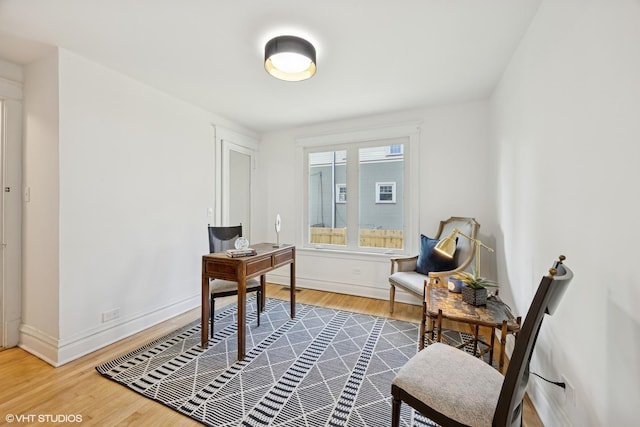 home office with wood finished floors and baseboards
