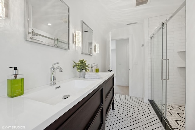 bathroom with a stall shower, vanity, and recessed lighting