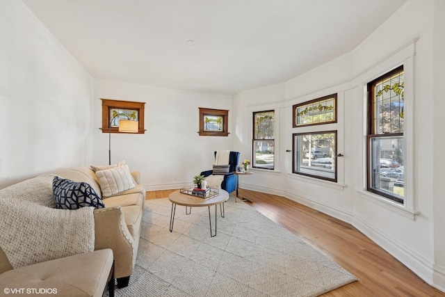living area with wood finished floors and baseboards