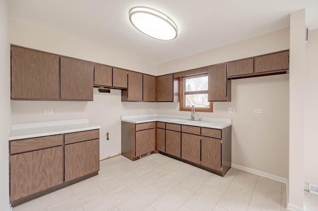 kitchen featuring a sink and light countertops
