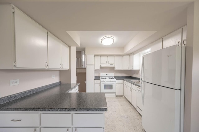 kitchen with under cabinet range hood, white appliances, white cabinetry, a peninsula, and dark countertops