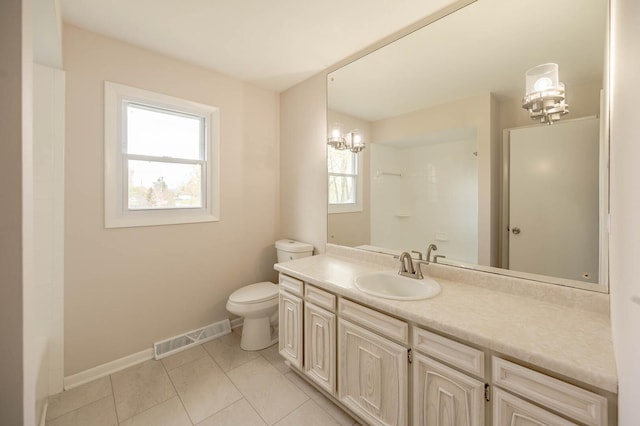 bathroom featuring toilet, vanity, visible vents, tile patterned flooring, and baseboards