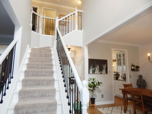 39W935 Berkshire Ct, Geneva, IL 60134 - stairs with crown molding, baseboards, wood finished floors, and a high ceiling