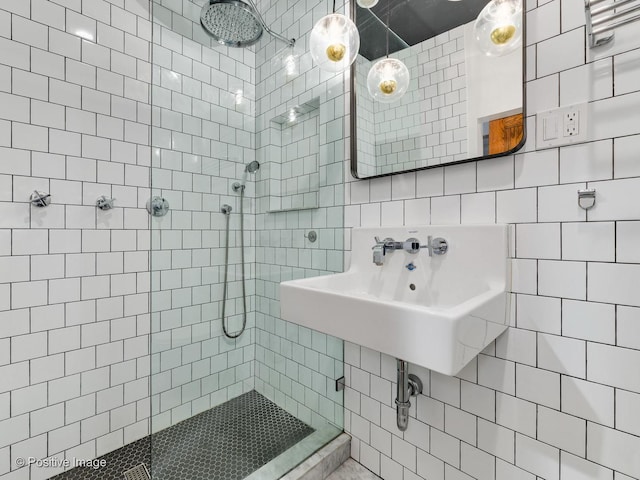 bathroom featuring tile walls and a tile shower