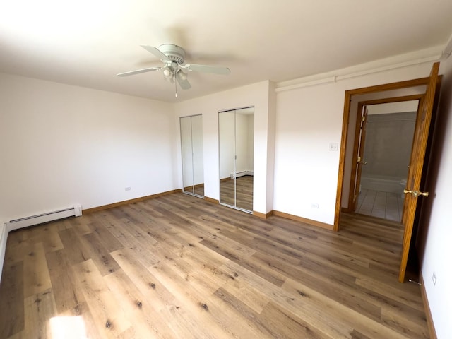 10310 Ridgeland Ave Unit 307, Chicago Ridge, IL 60415 - unfurnished bedroom with baseboards, baseboard heating, two closets, and wood finished floors