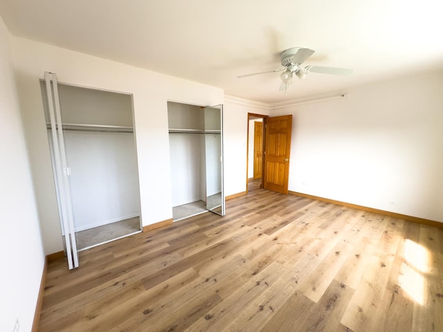10310 Ridgeland Ave Unit 307, Chicago Ridge, IL 60415 - unfurnished bedroom featuring two closets, baseboards, a ceiling fan, and wood finished floors