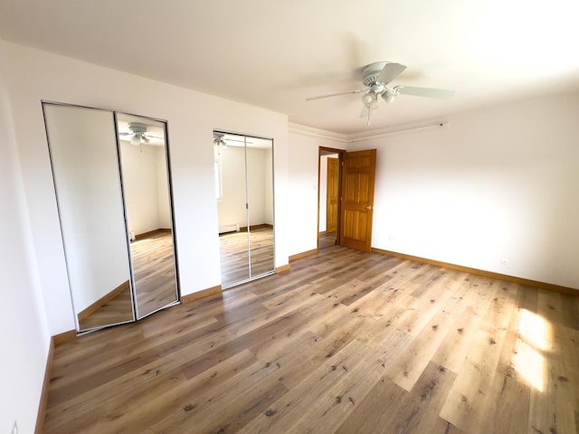 10310 Ridgeland Ave Unit 307, Chicago Ridge, IL 60415 - unfurnished bedroom with two closets, baseboards, a ceiling fan, and wood finished floors