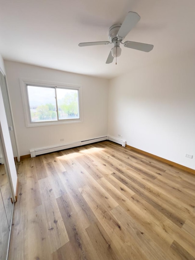 10310 Ridgeland Ave Unit 307, Chicago Ridge, IL 60415 - unfurnished bedroom with baseboards, ceiling fan, a baseboard radiator, and light wood-type flooring