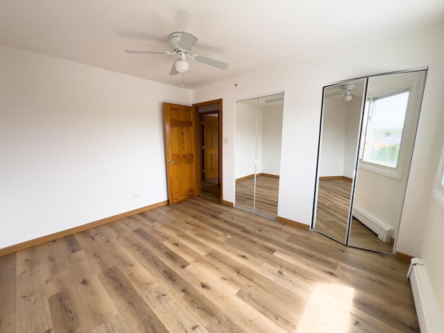 10310 Ridgeland Ave Unit 307, Chicago Ridge, IL 60415 - unfurnished bedroom featuring two closets, baseboard heating, and light wood-style floors