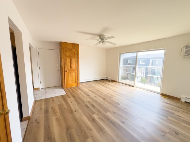 10310 Ridgeland Ave Unit 307, Chicago Ridge, IL 60415 - unfurnished room featuring a ceiling fan, a baseboard radiator, an AC wall unit, baseboards, and light wood-type flooring