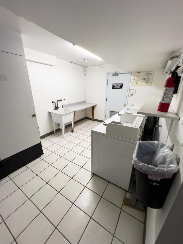 10310 Ridgeland Ave Unit 307, Chicago Ridge, IL 60415 - common laundry area featuring washing machine and dryer, light tile patterned flooring, and a sink