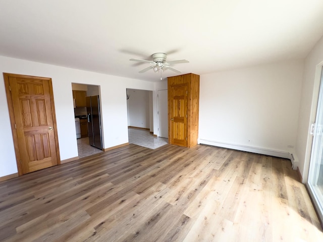 10310 Ridgeland Ave Unit 307, Chicago Ridge, IL 60415 - unfurnished bedroom featuring a ceiling fan, a baseboard radiator, black refrigerator with ice dispenser, baseboards, and wood finished floors