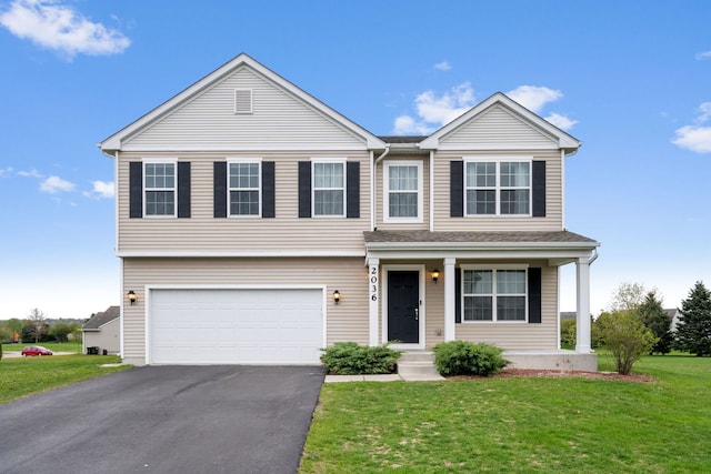view of front of home featuring covered porch, an attached garage, a front yard, and aphalt driveway