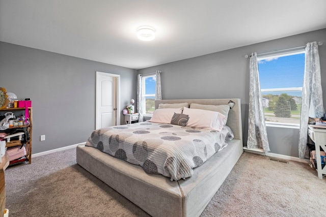 bedroom featuring baseboards, visible vents, and carpet